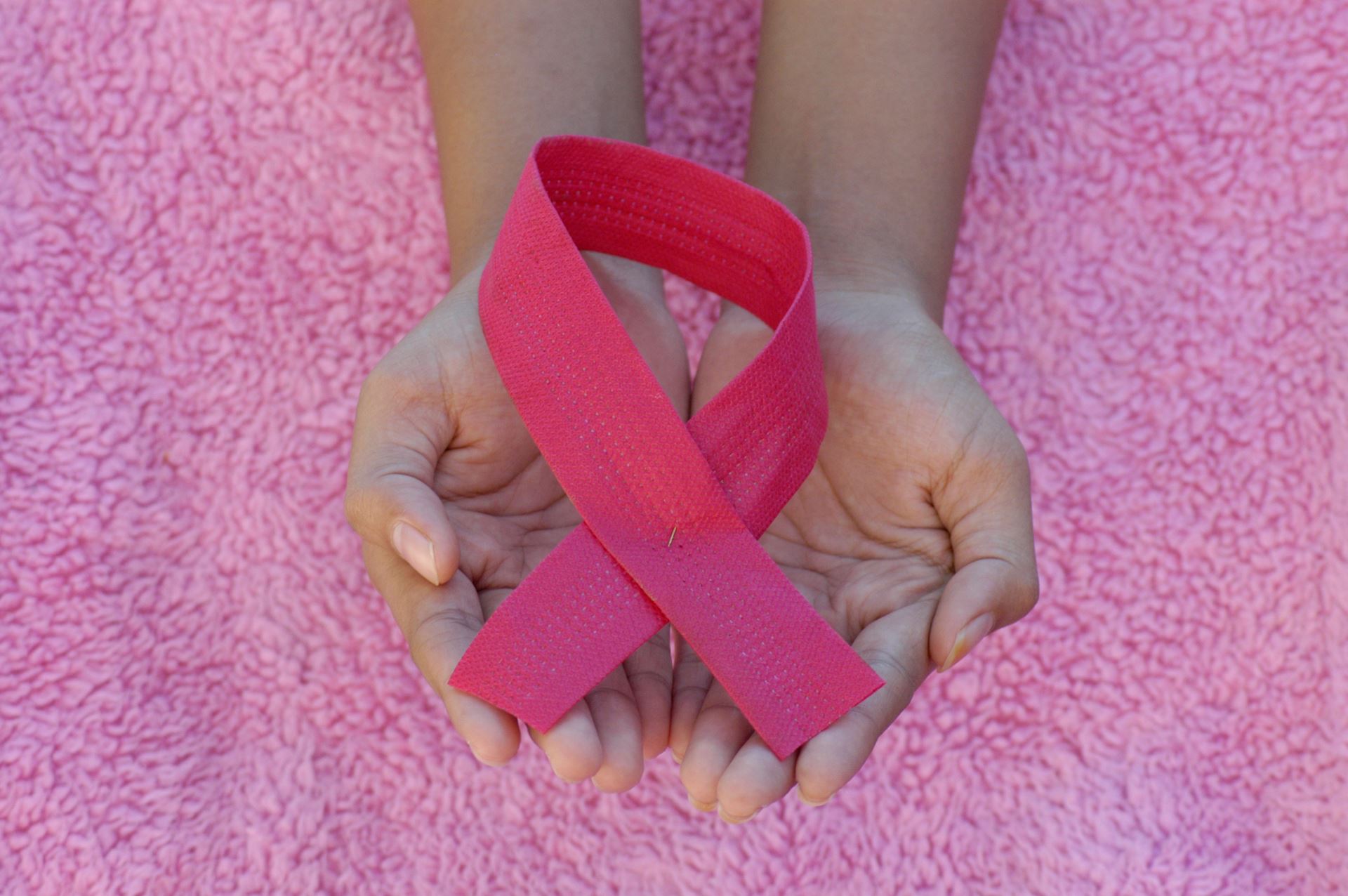 Cancer ribbon in hands
